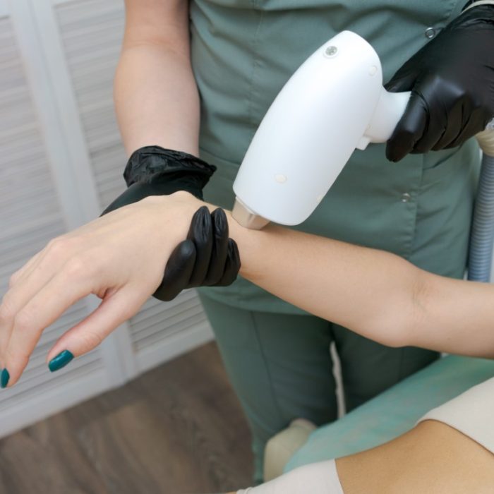 Laser hair removal and cosmetology in a beauty salon. Hair removal procedure. Laser hair removal, cosmetology, spa and hair removal concept. Beautiful young caucasian woman on procedure